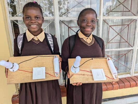 WellSpring children holding school project